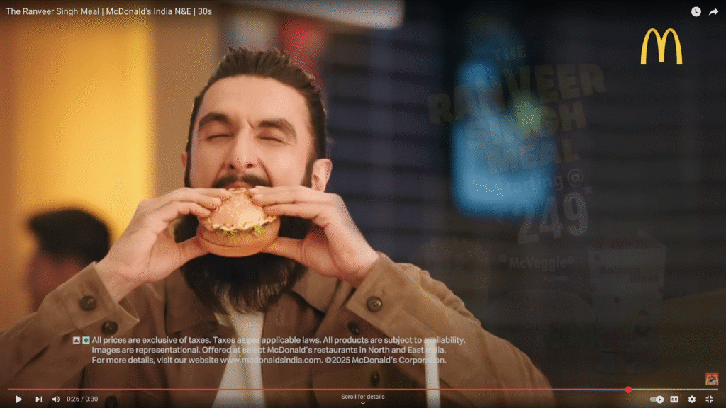 McDonald's advertisement for the Ranveer Singh Meal, showing a close-up of hands holding a burger, with prominent branding and meal items in the frame.